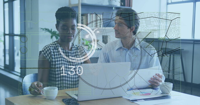 Two colleagues reviewing charts and checking smartphone at desk near windows, with circuit overlay