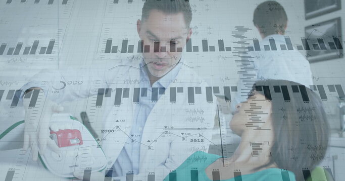 Applying defibrillator paddles, physician in white coat shocking patient in clinic with ECG graphs
