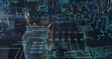 Talking IT engineer holding smartphone to ear in dim tech lab, with holographic neon circuitry