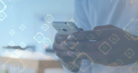 Tapping user's smartphone screen at office desk, displaying floating 6G network icons, copy space