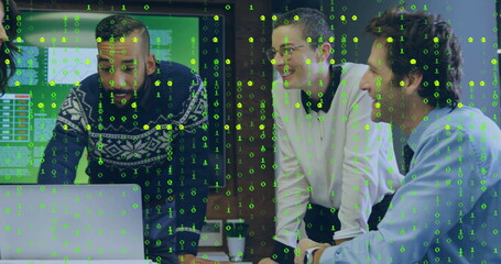 Leaning team in office using laptop, displaying binary code overlay with monitors and coffee cup