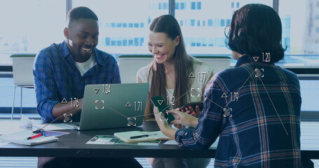 Working team analyzing data in meeting room, with laptop, smartphone, documents, notepad and pens