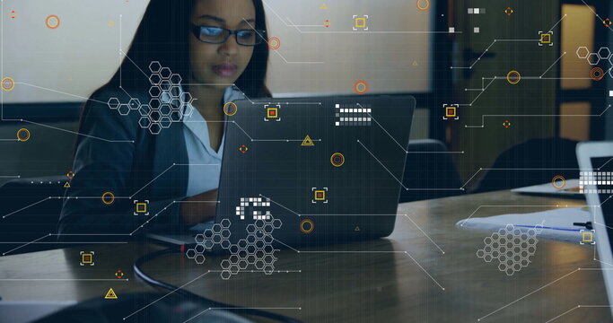 Businesswoman wearing eyeglasses typing on laptop at meeting table with floating network overlays