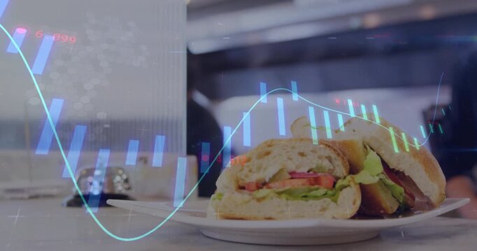 Gloved hand sliding sandwich plate into frame while chef analyzing financial charts tracking sales