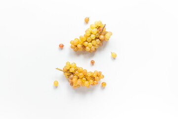 Many bunches of ripe yellow grapes on white background, top view