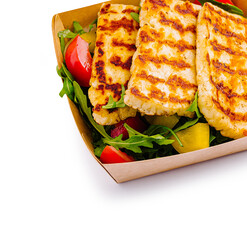 Grilled cheese platter served with fresh salad on a sunny day outdoors