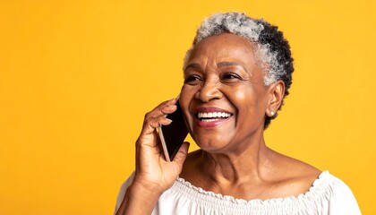 Cheerful senior woman engaged in a phone call with joyful expression against a vibrant background