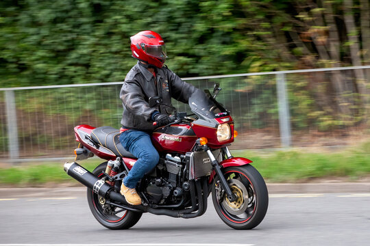 Milton Keynes,Bucks,UK - Aug 3rd 2025:  1998 red Kawasaki zrx1100  motorcycle travelling on a British road