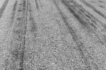 Black tire marks on road, Black rubber tire marks and tread marks, Tire trace track wheels texture and background, Auto tire tread grunge, Car wheel tyre tread track black tyre print, Aerial view.