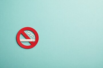 Red no smoking sign on light teal background
