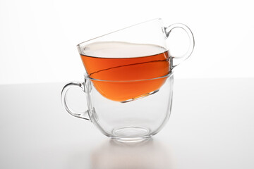 Tea strain resting on a glass cup filled with tea