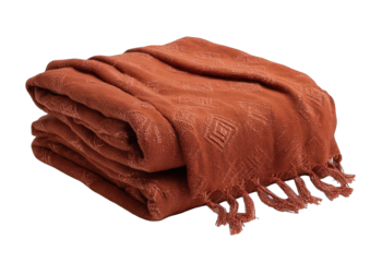 Folded terracotta throw blanket with diamond pattern and fringe