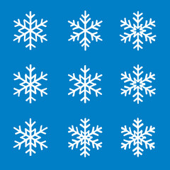 Set of nine white snowflakes on blue background, winter holiday season decoration isolated