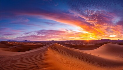 Naklejka premium desert sunset with vibrant colors in the sky and dunes stretching endlessly into the horizon