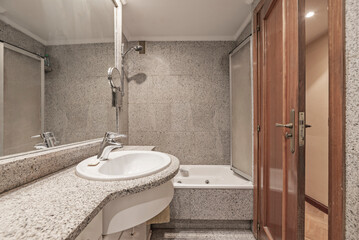 Modern bathroom design with an integrated porcelain sink, a touch-sensitive faucet, and a corner glass shower enclosure