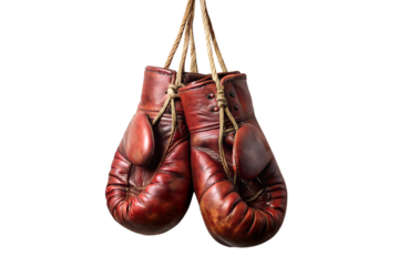 Pair of aged red leather boxing gloves hanging by their laces isolated on transparent background, showcasing vintage sports equipment with worn texture