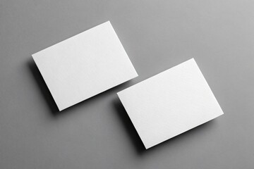 Two Blank White Rectangular Cards on a Gray Background