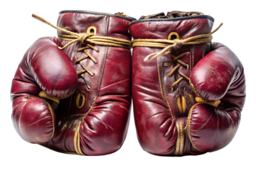 A pair of vintage red leather boxing gloves isolated on transparent background, showcasing a classic sport equipment with worn texture and aged details