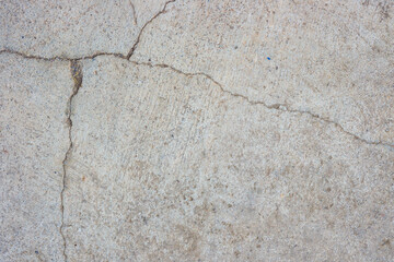 Close-up of cracked and rough concrete for overlay background.