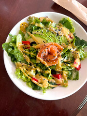 Salad with smoked salmon, avocado, and green leaves. Ideal healthy lunch or dinner concept.