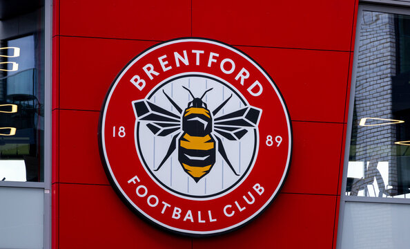 LONDON, UK - AUGUST 5, 2025 - Close up of Brentford FC logo featuring a bee, symbolizing the team s nickname The Bees, on a red wall of their stadium in London, UK