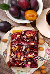 Top view of homemade plum cake  and fresh fruits