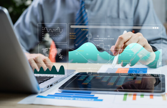 Project management concept. Business professionals using laptops to manage ongoing tasks, update schedules, and plan projects with axis charts and scheduling software tools.