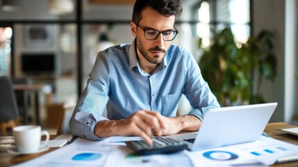 Fototapeta premium Man looking at financial report with calculator