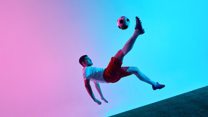 Dynamic bicycle kick in neon gradient soccer action scene. Concept of skill, creativity, and peak performance for sports campaigns, athletic branding, and motivational sports-related visuals.