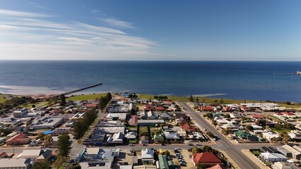Ardrossan, Yorke Peninsula, South Australia: Aerial Drone View of Coastal Red Cliffs, Jetty, Sandy Shoreline, and Picturesque Seaside Town with Farmland Backdrop