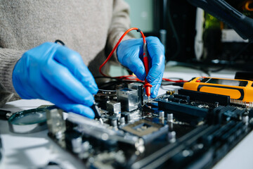 Electronics technician, electronic engineering electronic repair, electronics measuring and testing, repair and maintenance concepts.uses a voltage meter to check