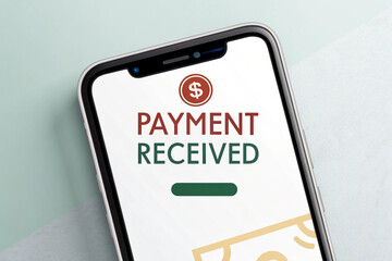Smartphone displaying payment received confirmation with dollar sign