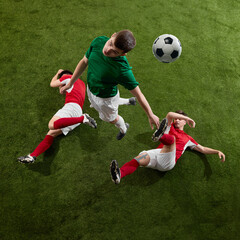 Soccer player leaping high above rivals in dramatic header attempt. Concept of determination, leadership, aerial dominance, and marketing visuals for sports branding.