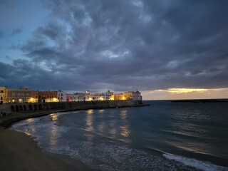 Twilight Over Coastal Town With Illuminated Seafront