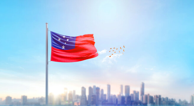 Samoa national flag waving in beautiful building skyline. - Powered by Adobe