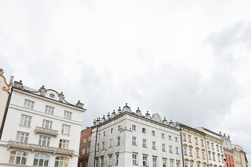 People walking in the historic main square of Krakow, Poland with old buildings