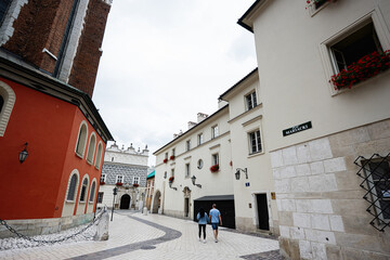 Charming Krakow street with colorful buildings and strolling couple