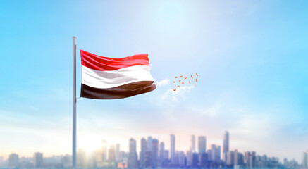 Yemen national flag waving with skyline and buildings. Yemen national flag for independence day.
