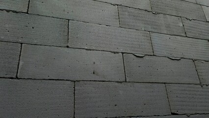 Grey Textured Concrete Blocks Forming a Wall , Detailed View of Cement Bricks in a Structured Pattern