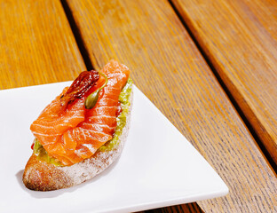 Delicious salmon appetizer served on crispy bread at a cozy cafe