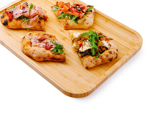 Artisan flatbreads with fresh toppings served on a wooden tray