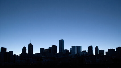Professional city skyline silhouette in monochrome blue gradient with space for business slogans.