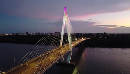 Obraz premium Modern cable-stayed bridge at twilight over a river.