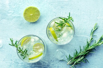 Gin tonic, overhead flat lay shot with rosemary and lime. Fresh summer cocktail with ice © laplateresca