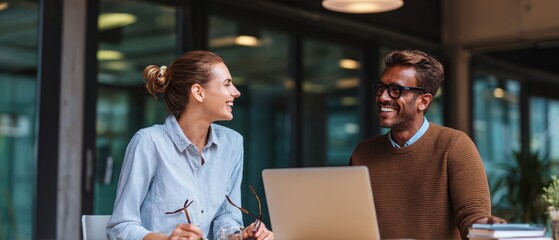 The cheerful professionals collaborating on a project in a modern office space.