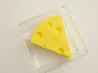 Cheese shaped cheesecake on plastic container