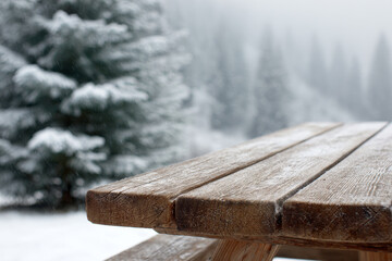 Wooden picnic table with snow in peaceful winter landscape