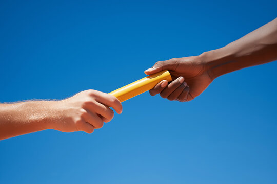 Relay race runner passing the baton against blue sky