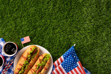 Labor Day and Independence Day celebration concept featuring a picnic party on grass with American colors and foods including hot dogs and drinks, symbolizing a festive and patriotic atmosphere