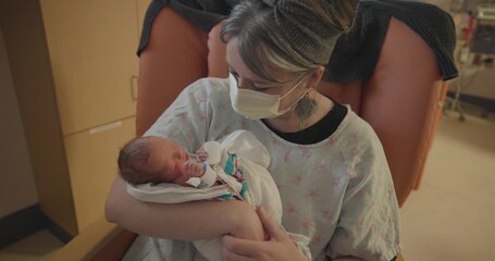 New Born Preemie Baby Being Held By Mom with Surgical Mask